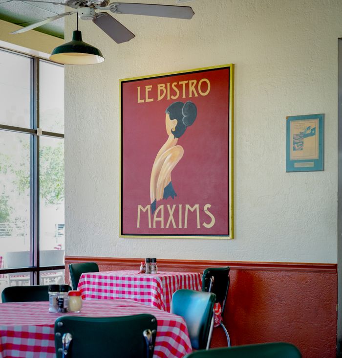 our-experience Cozy bistro in Houston with vintage poster and checkered tablecloths.